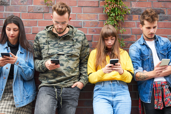 front-view-two-young-couples-with-mobile-phone700.jpg