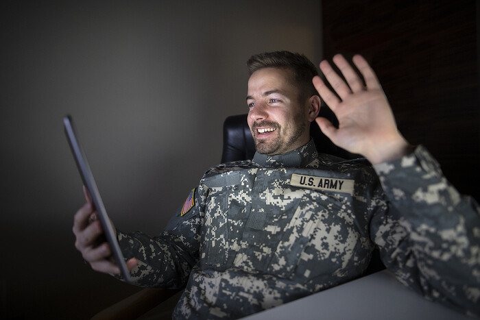 american-off-duty-soldier-military-uniform-holding-tablet-computer-waving-his-family_1.jpg